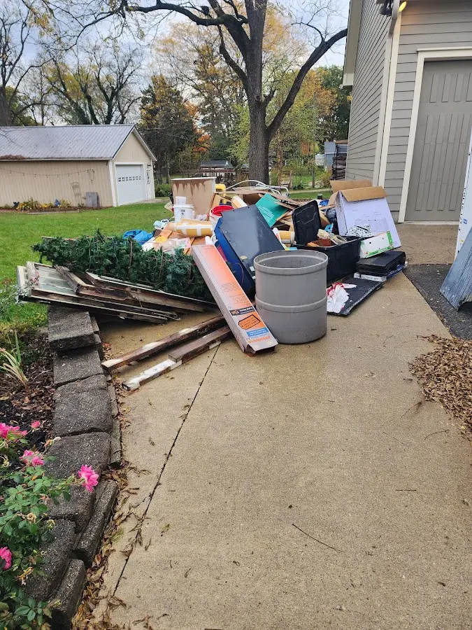 Dumpster being loaded with debris for 12 Yard Dumpster Rental in Heidelberg